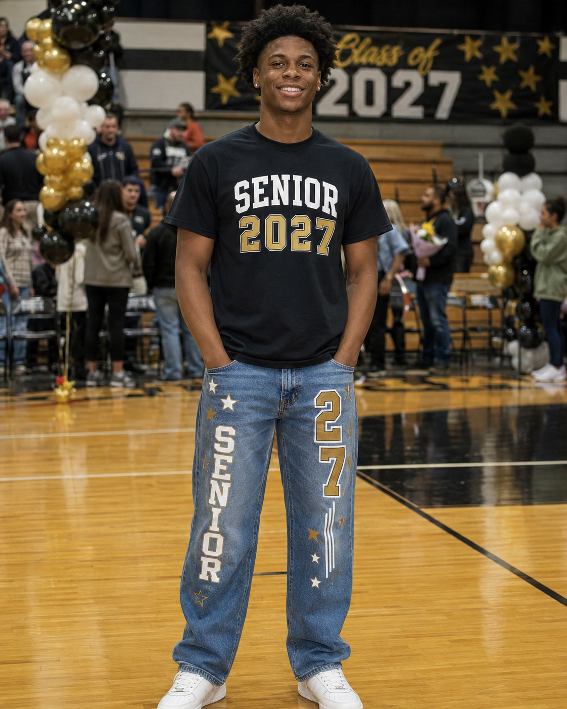 Male senior wearing a custom Senior 2027 shirt and decorated customer-supplied jeans in a school gym